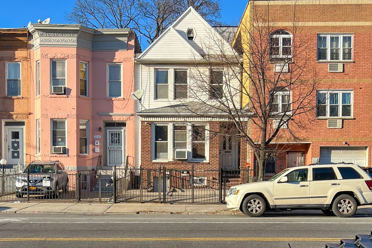 The same Brooklyn building before renovation: two stories with a peaked roof
